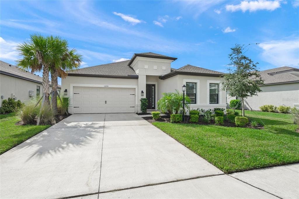 Front exterior of a new home in Park East at Azario, Bradenton, FL, highlighting curb appeal (Image 1). Front exterior of a new home in Park East at Azario, Bradenton, FL, highlighting curb appeal (Image 1).
