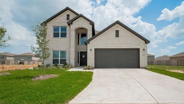 Front exterior of a new home in Sunterra, Park Row, TX, highlighting curb appeal (Image 1). Front exterior of a new home in Sunterra, Park Row, TX, highlighting curb appeal (Image 1).