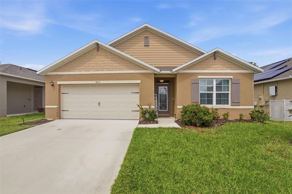 Front exterior of a new home in Cadence at Parc Hill, Orange City, FL, highlighting curb appeal (Image 1). Front exterior of a new home in Cadence at Parc Hill, Orange City, FL, highlighting curb appeal (Image 1).