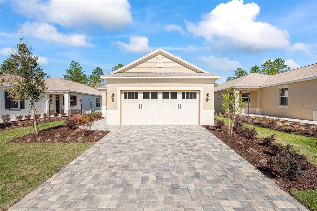 Front exterior of a new home in On Top of the World Communities, Ocala, FL, highlighting curb appeal (Image 1). Front exterior of a new home in On Top of the World Communities, Ocala, FL, highlighting curb appeal (Image 1).