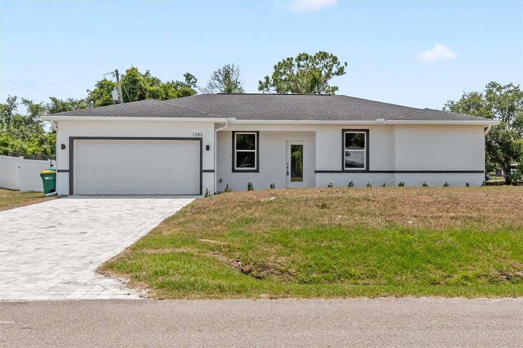 Front exterior of a new home in , Port Charlotte, FL, highlighting curb appeal (Image 1). Front exterior of a new home in , Port Charlotte, FL, highlighting curb appeal (Image 1).