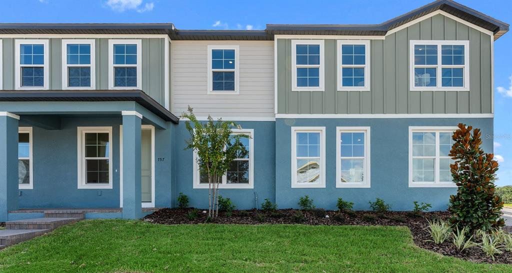 Front exterior of a new home in Eden Crest Townhomes, Apopka, FL, highlighting curb appeal (Image 1). Front exterior of a new home in Eden Crest Townhomes, Apopka, FL, highlighting curb appeal (Image 1).