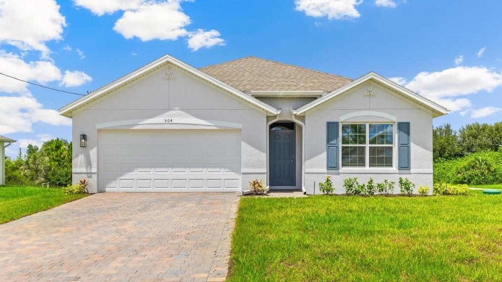 Front exterior of a new home in Burnt Store Village, Punta Gorda, FL, highlighting curb appeal (Image 1). Front exterior of a new home in Burnt Store Village, Punta Gorda, FL, highlighting curb appeal (Image 1).