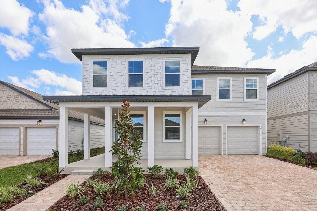 Front exterior of a new home in Trailside, Mount Dora, FL, highlighting curb appeal (Image 1). Front exterior of a new home in Trailside, Mount Dora, FL, highlighting curb appeal (Image 1).