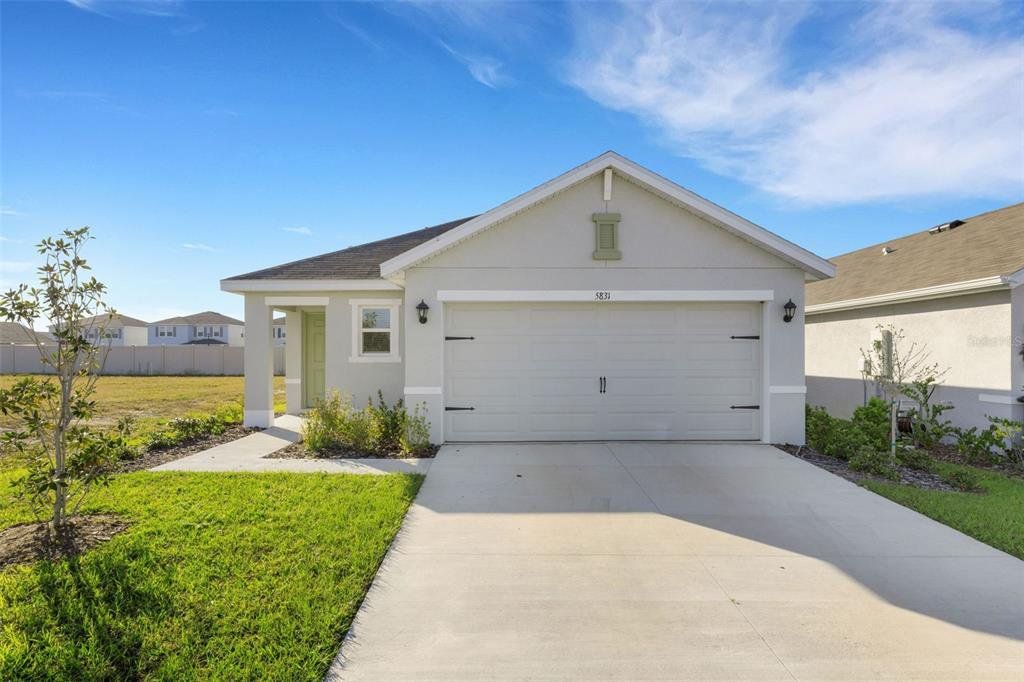 Front exterior of a new home in Silverstone North, Palmetto, FL, highlighting curb appeal (Image 1). Front exterior of a new home in Silverstone North, Palmetto, FL, highlighting curb appeal (Image 1).
