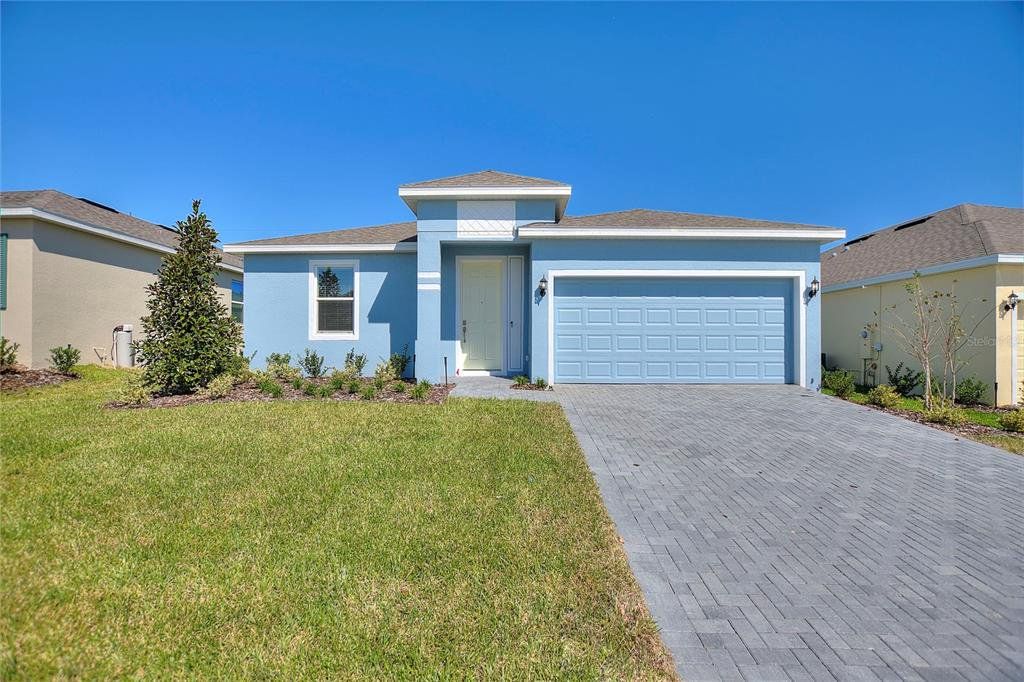 Front exterior of a new home in Cypress Park Estates, Haines City, FL, highlighting curb appeal (Image 1). Front exterior of a new home in Cypress Park Estates, Haines City, FL, highlighting curb appeal (Image 1).