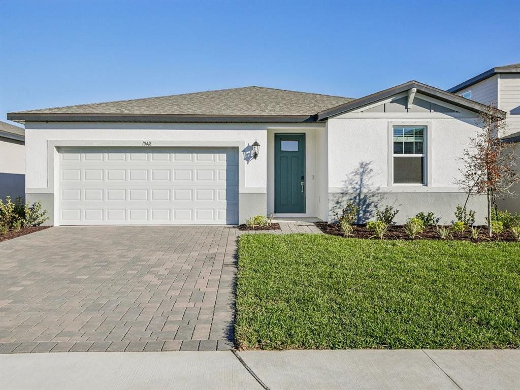 Front exterior of a new home in Oakfield Trails - Classic Series, Parrish, FL, highlighting curb appeal (Image 1). Front exterior of a new home in Oakfield Trails - Classic Series, Parrish, FL, highlighting curb appeal (Image 1).