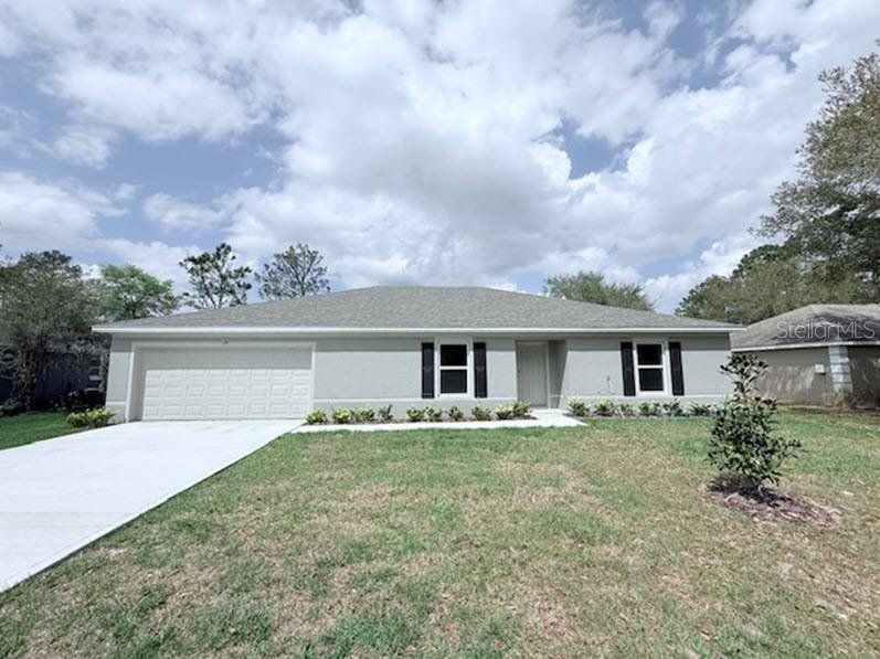 Front exterior of a new home in Palm Coast, Palm Coast, FL, highlighting curb appeal (Image 1). Front exterior of a new home in Palm Coast, Palm Coast, FL, highlighting curb appeal (Image 1).