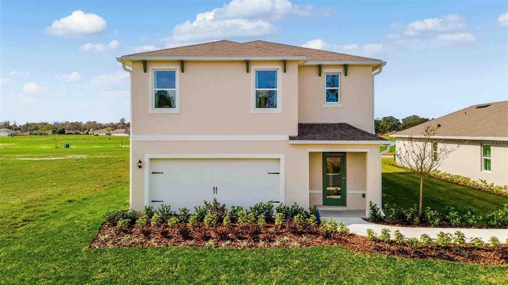 Front exterior of a new home in Kindred, Kissimmee, FL, highlighting curb appeal (Image 1). Front exterior of a new home in Kindred, Kissimmee, FL, highlighting curb appeal (Image 1).