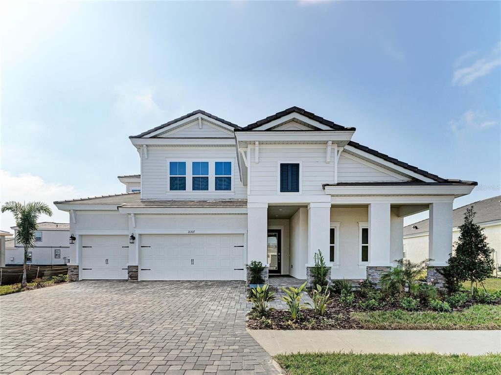 Front exterior of a new home in North River Ranch, Parrish, FL, highlighting curb appeal (Image 1). Front exterior of a new home in North River Ranch, Parrish, FL, highlighting curb appeal (Image 1).