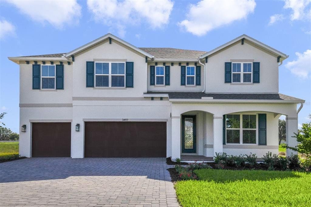 Front exterior of a new home in Acuera Estates, Apopka, FL, highlighting curb appeal (Image 1).