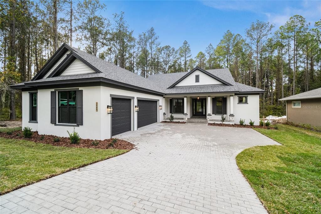Front exterior of a new home in Southern Hills Plantation, Brooksville, FL, highlighting curb appeal (Image 1). Front exterior of a new home in Southern Hills Plantation, Brooksville, FL, highlighting curb appeal (Image 1).