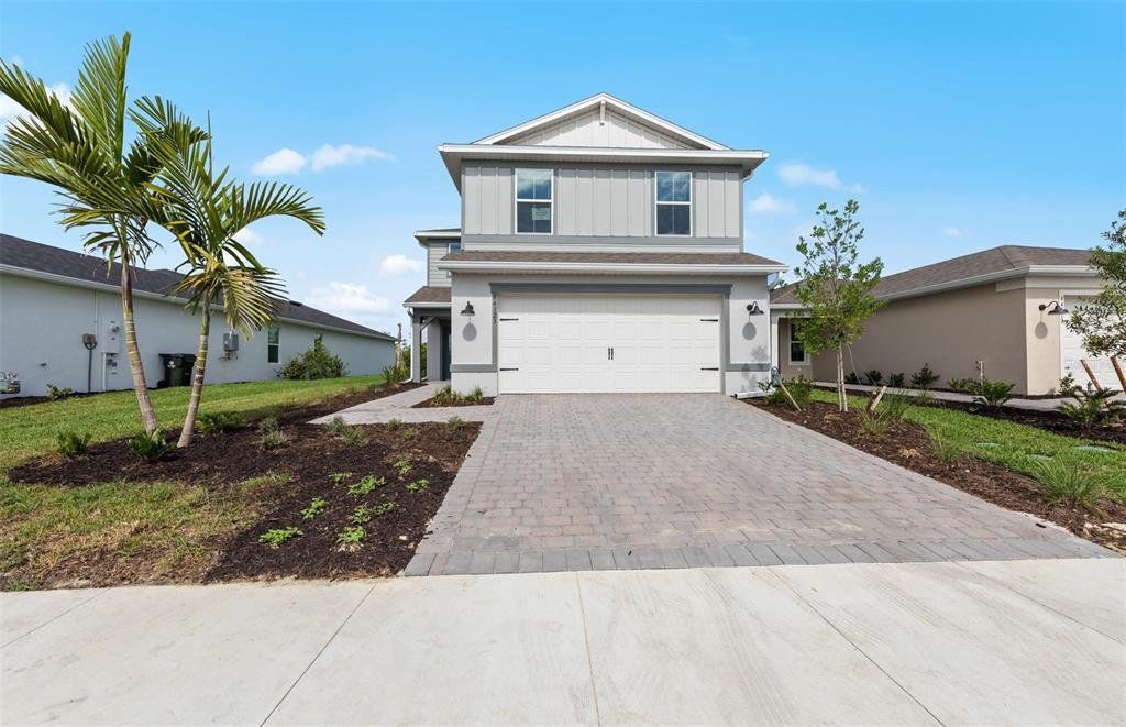 Front exterior of a new home in Reagan Landing, Bradenton, FL, highlighting curb appeal (Image 1). Front exterior of a new home in Reagan Landing, Bradenton, FL, highlighting curb appeal (Image 1).