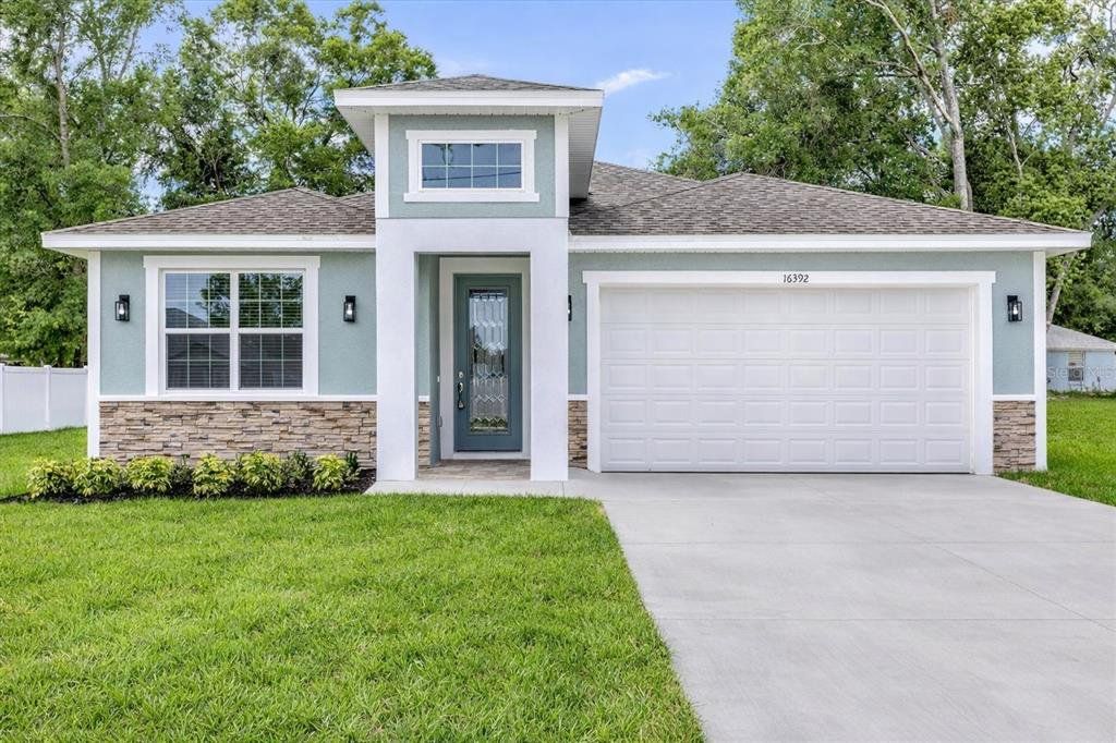 Front exterior of a new home in , Summerfield, FL, highlighting curb appeal (Image 1). Front exterior of a new home in , Summerfield, FL, highlighting curb appeal (Image 1).