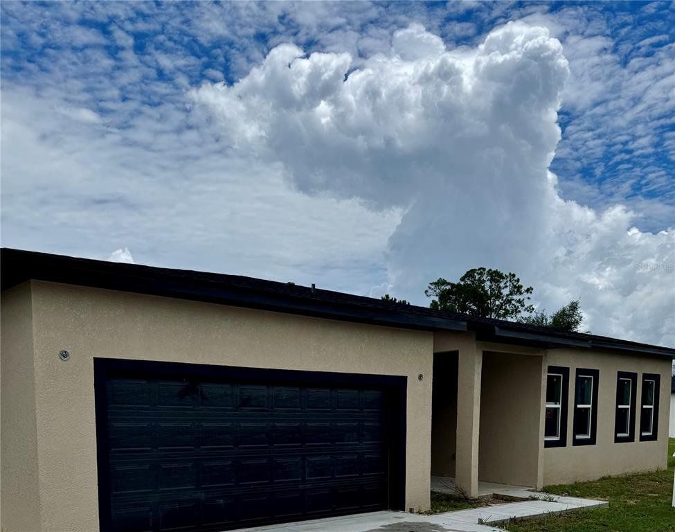 Front exterior of a new home in , Leesburg, FL, highlighting curb appeal (Image 1). Front exterior of a new home in , Leesburg, FL, highlighting curb appeal (Image 1).