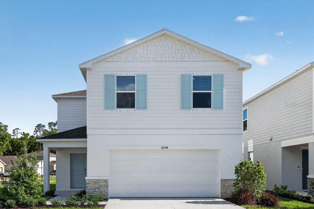 Front exterior of a new home in Palm Wind, Hudson, FL, highlighting curb appeal (Image 1). Front exterior of a new home in Palm Wind, Hudson, FL, highlighting curb appeal (Image 1).