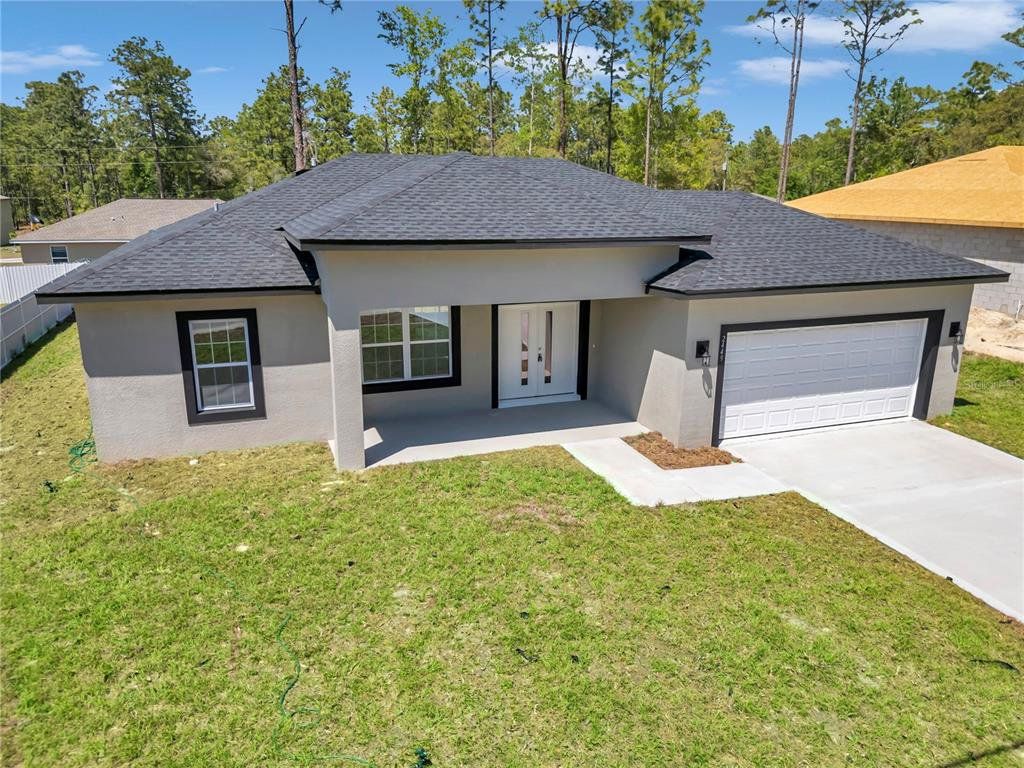 Front exterior of a new home in , Citrus Springs, FL, highlighting curb appeal (Image 1). Front exterior of a new home in , Citrus Springs, FL, highlighting curb appeal (Image 1).