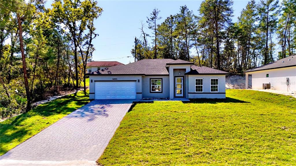 Front exterior of a new home in , Ocala, FL, highlighting curb appeal (Image 1). Front exterior of a new home in , Ocala, FL, highlighting curb appeal (Image 1).