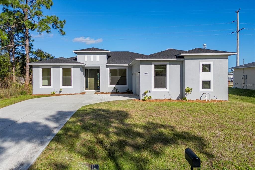 Front exterior of a new home in , Palm Bay, FL, highlighting curb appeal (Image 1). Front exterior of a new home in , Palm Bay, FL, highlighting curb appeal (Image 1).