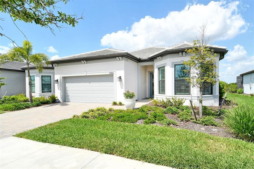 Front exterior of a new home in , Nokomis, FL, highlighting curb appeal (Image 1). Front exterior of a new home in , Nokomis, FL, highlighting curb appeal (Image 1).