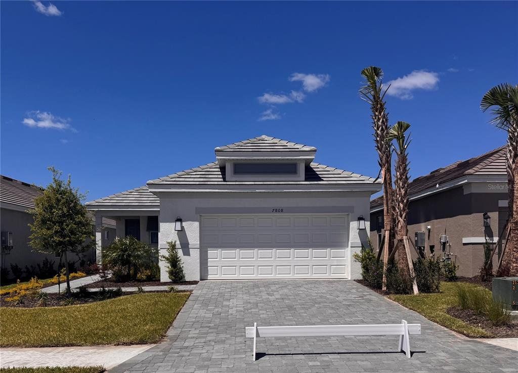 Front exterior of a new home in Coasterra Community Group Page, Palmetto, FL, highlighting curb appeal (Image 1). Front exterior of a new home in Coasterra Community Group Page, Palmetto, FL, highlighting curb appeal (Image 1).