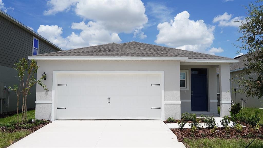 Front exterior of a new home in Cascades, Davenport, FL, highlighting curb appeal (Image 1). Front exterior of a new home in Cascades, Davenport, FL, highlighting curb appeal (Image 1).