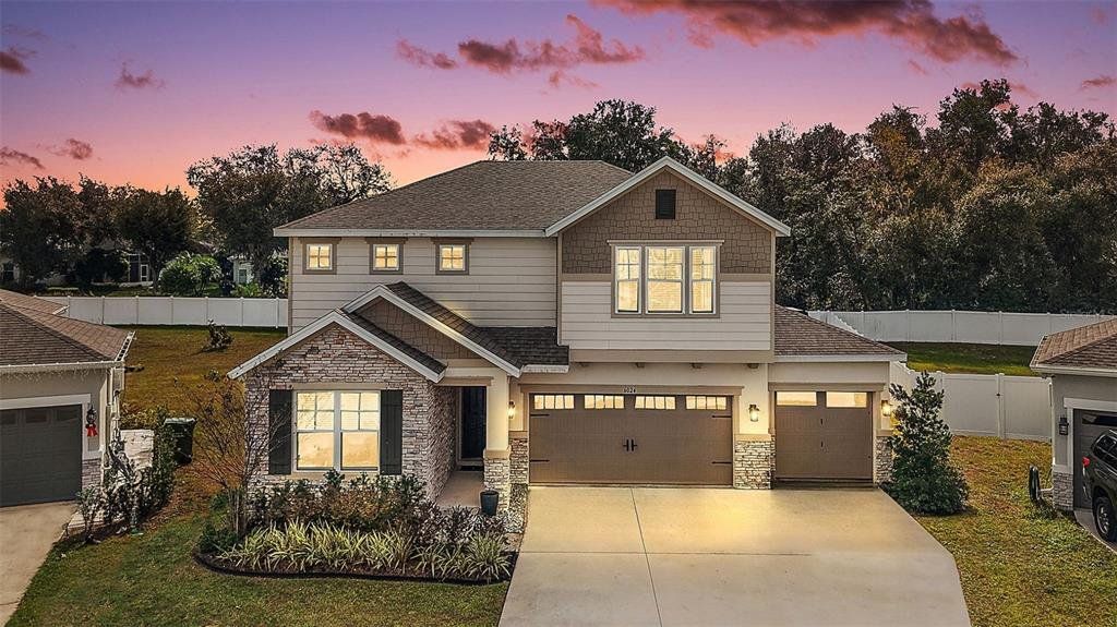 Front exterior of a new home in Seasons at Spring Creek, Okahumpka, FL, highlighting curb appeal (Image 1). Front exterior of a new home in Seasons at Spring Creek, Okahumpka, FL, highlighting curb appeal (Image 1).