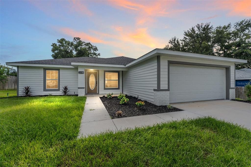 Front exterior of a new home in , Summerfield, FL, highlighting curb appeal (Image 1).