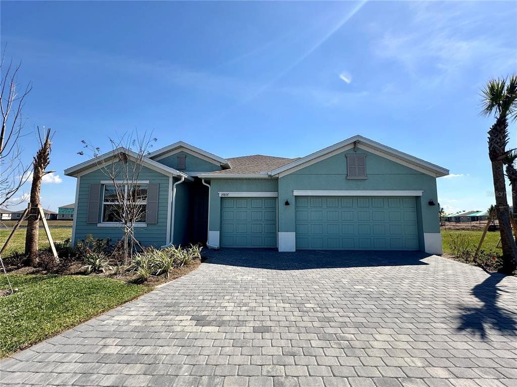 Front exterior of a new home in Rye Ranch, Parrish, FL, highlighting curb appeal (Image 1). Front exterior of a new home in Rye Ranch, Parrish, FL, highlighting curb appeal (Image 1).