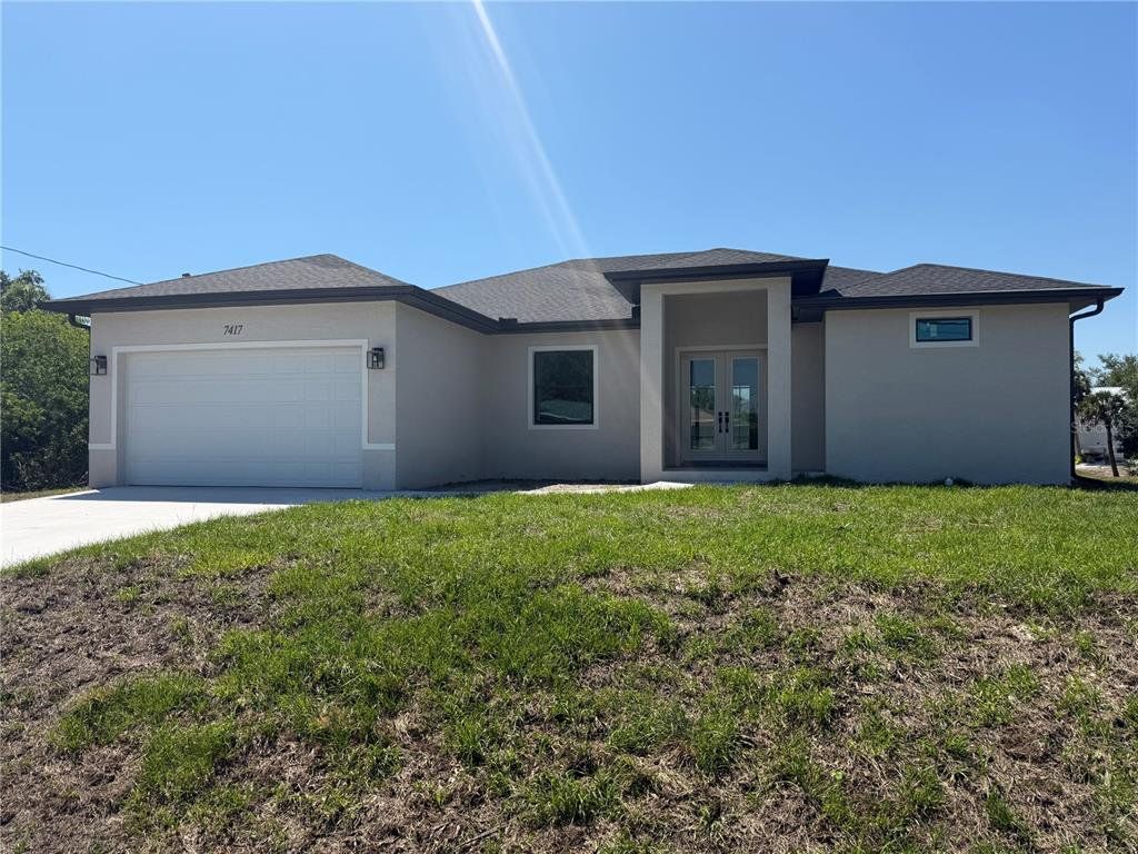 Front exterior of a new home in , Port Charlotte, FL, highlighting curb appeal (Image 1). Front exterior of a new home in , Port Charlotte, FL, highlighting curb appeal (Image 1).