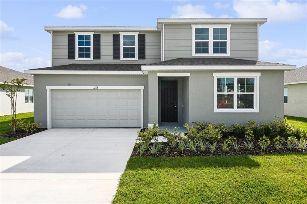 Front exterior of a new home in Seasons at Bella Vista, Dundee, FL, highlighting curb appeal (Image 1). Front exterior of a new home in Seasons at Bella Vista, Dundee, FL, highlighting curb appeal (Image 1).