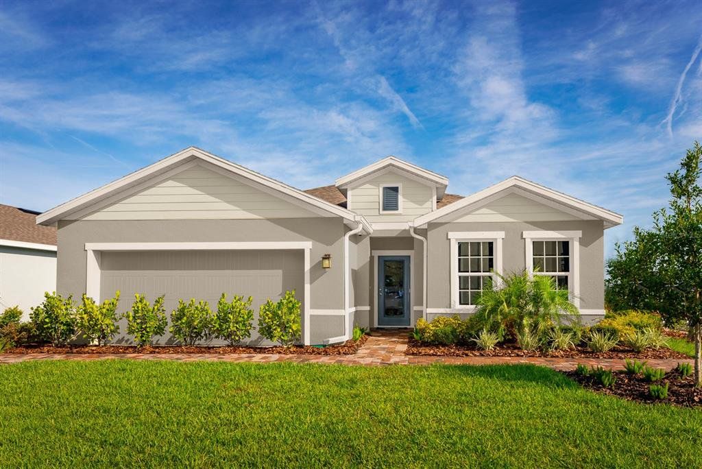 Front exterior of a new home in Overlook at Grassy Lake, Minneola, FL, highlighting curb appeal (Image 1). Front exterior of a new home in Overlook at Grassy Lake, Minneola, FL, highlighting curb appeal (Image 1).