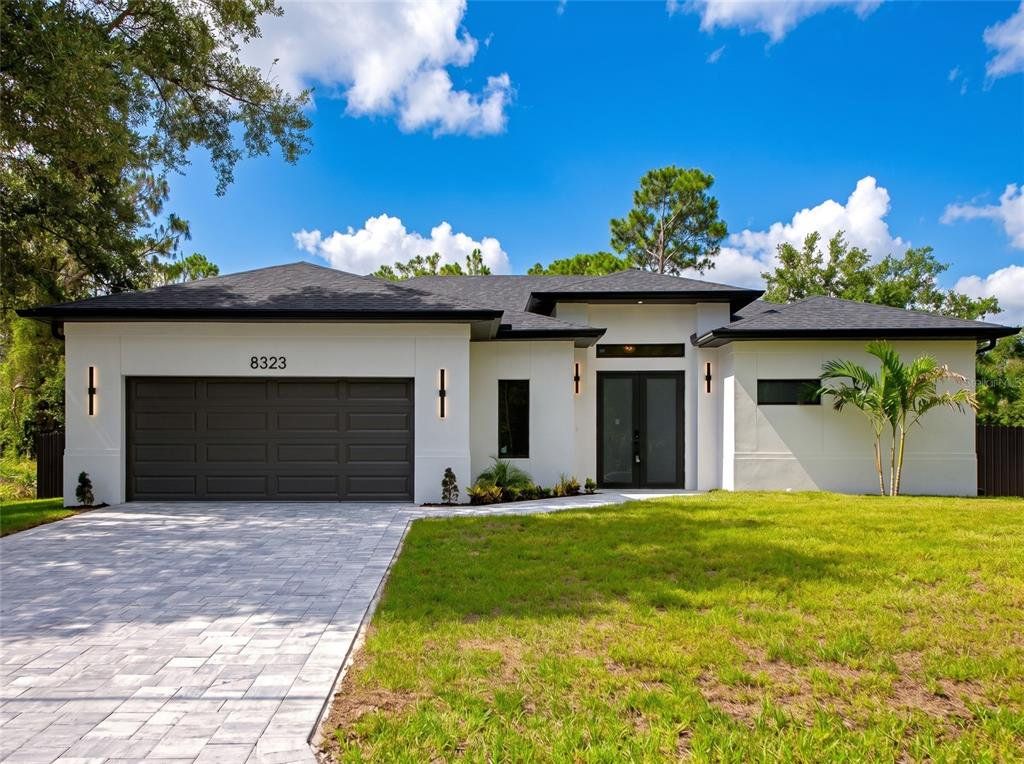 Front exterior of a new home in , North Port, FL, highlighting curb appeal (Image 1). Front exterior of a new home in , North Port, FL, highlighting curb appeal (Image 1).