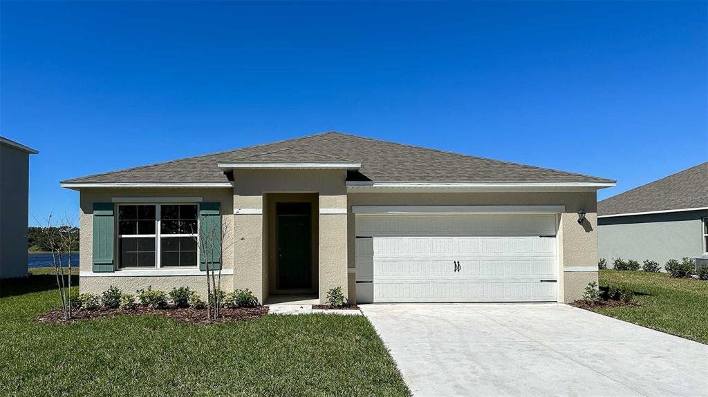 Front exterior of a new home in Oak Leaf Preserve, New Smyrna Beach, FL, highlighting curb appeal (Image 1). Front exterior of a new home in Oak Leaf Preserve, New Smyrna Beach, FL, highlighting curb appeal (Image 1).