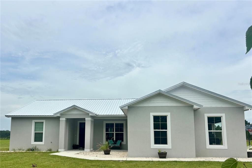 Front exterior of a new home in , Fort Meade, FL, highlighting curb appeal (Image 1). Front exterior of a new home in , Fort Meade, FL, highlighting curb appeal (Image 1).