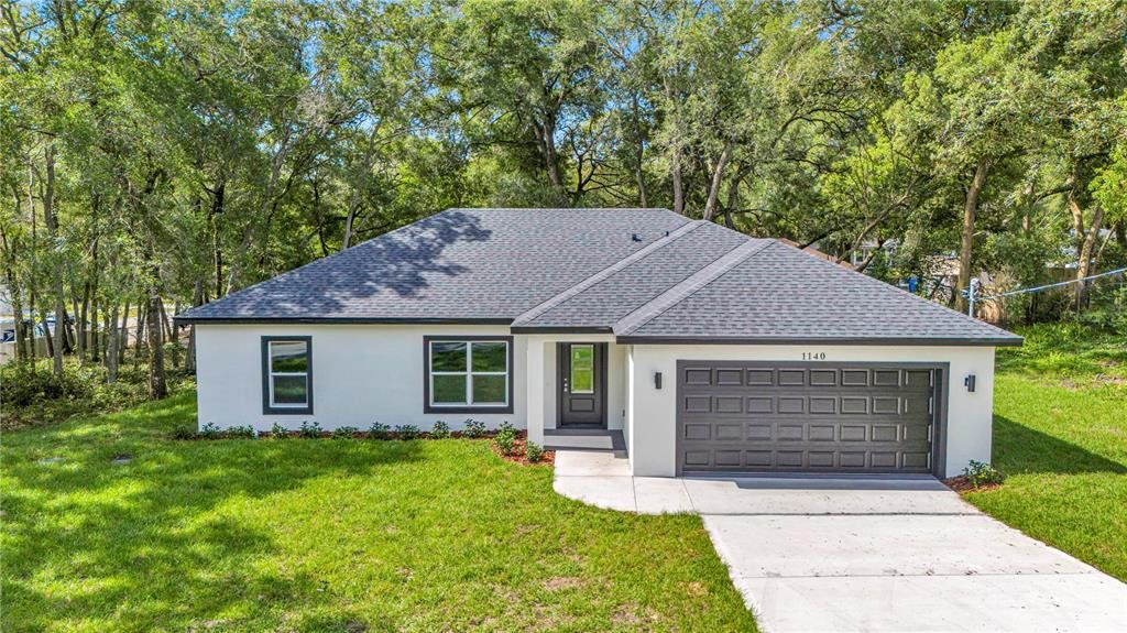 Front exterior of a new home in , Orange City, FL, highlighting curb appeal (Image 1). Front exterior of a new home in , Orange City, FL, highlighting curb appeal (Image 1).
