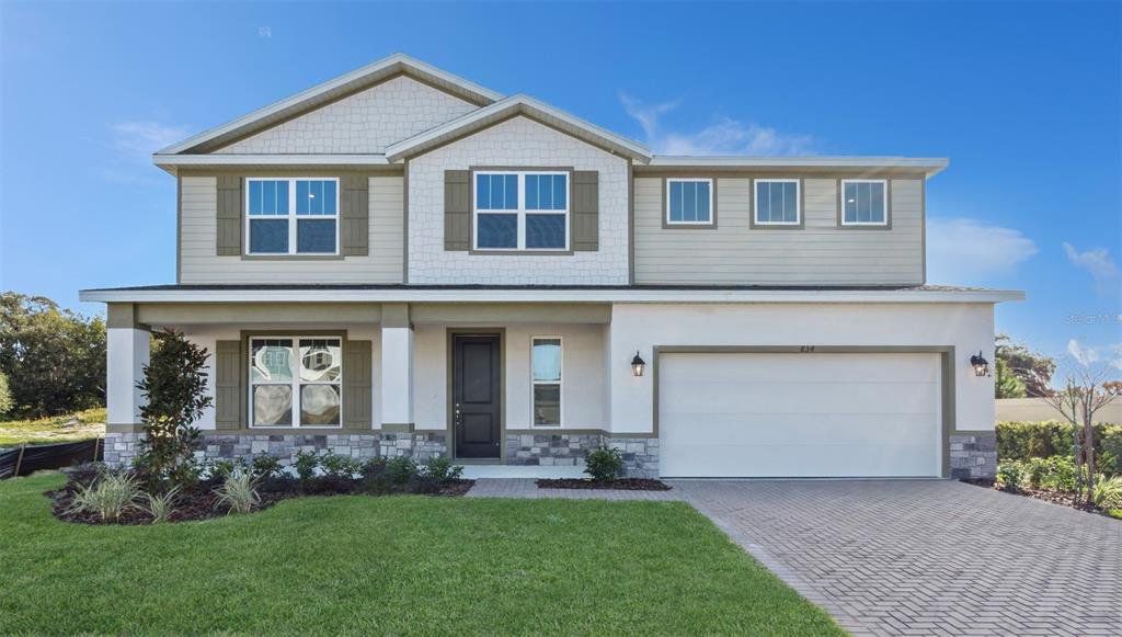 Front exterior of a new home in Eden Crest, Apopka, FL, highlighting curb appeal (Image 1). Front exterior of a new home in Eden Crest, Apopka, FL, highlighting curb appeal (Image 1).