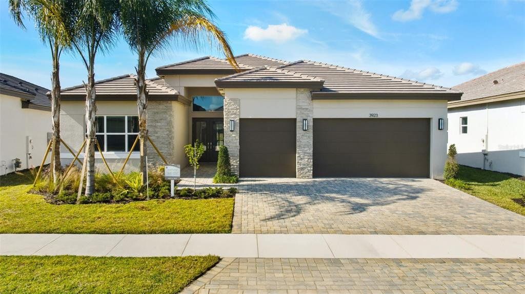 Front exterior of a new home in Valencia Ridge (55+), Wesley Chapel, FL, highlighting curb appeal (Image 1). Front exterior of a new home in Valencia Ridge (55+), Wesley Chapel, FL, highlighting curb appeal (Image 1).