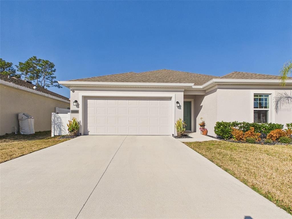 Front exterior of a new home in Vineland Reserve, Osteen, FL, highlighting curb appeal (Image 1). Front exterior of a new home in Vineland Reserve, Osteen, FL, highlighting curb appeal (Image 1).