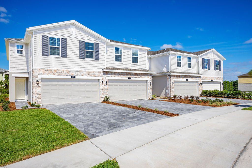 Front exterior of a new home in Thompson Village Townhomes, Apopka, FL, highlighting curb appeal (Image 1). Front exterior of a new home in Thompson Village Townhomes, Apopka, FL, highlighting curb appeal (Image 1).