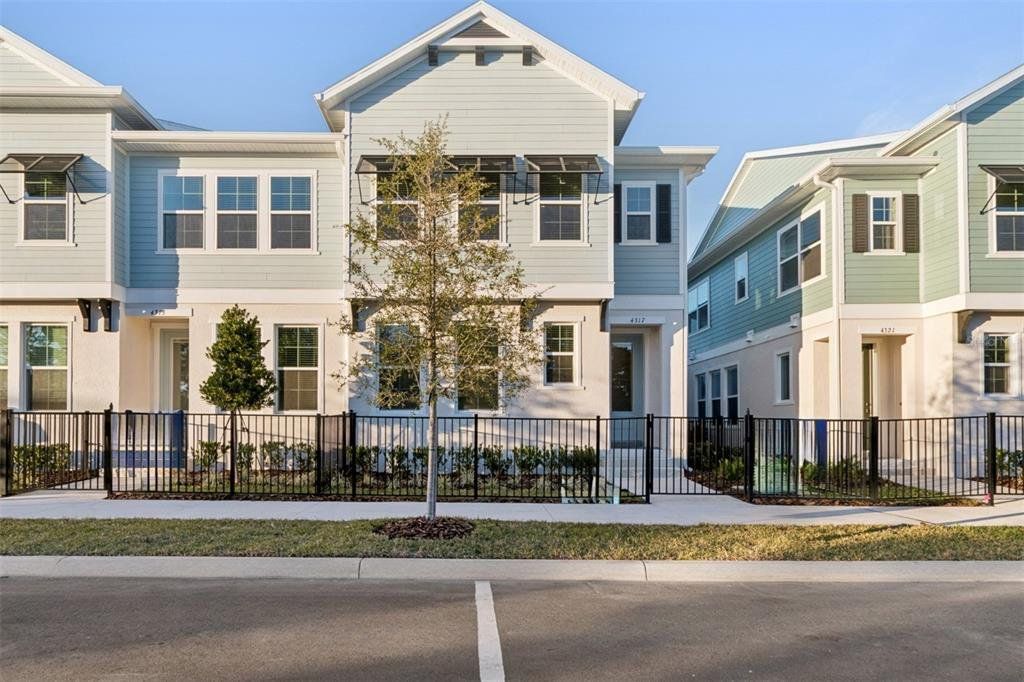Front exterior of a new home in Baldwin Crossing 22', Orlando, FL, highlighting curb appeal (Image 1). Front exterior of a new home in Baldwin Crossing 22', Orlando, FL, highlighting curb appeal (Image 1).