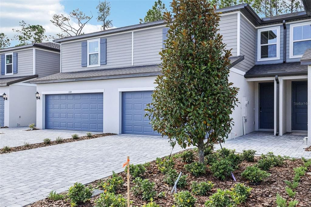 Front exterior of a new home in Bradford Park, Ormond Beach, FL, highlighting curb appeal (Image 1). Front exterior of a new home in Bradford Park, Ormond Beach, FL, highlighting curb appeal (Image 1).