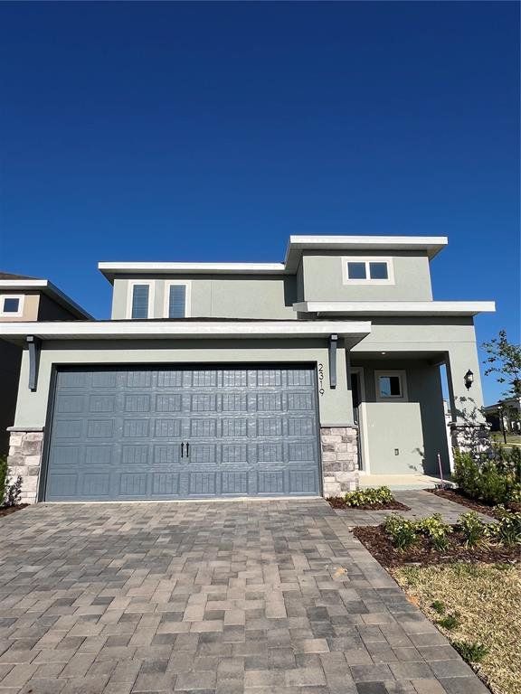 Front exterior of a new home in Hills of Minneola, Minneola, FL, highlighting curb appeal (Image 1). Front exterior of a new home in Hills of Minneola, Minneola, FL, highlighting curb appeal (Image 1).