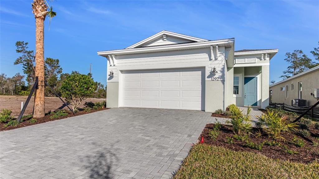 Front exterior of a new home in Cresswind DeLand, Deland, FL, highlighting curb appeal (Image 1). Front exterior of a new home in Cresswind DeLand, Deland, FL, highlighting curb appeal (Image 1).