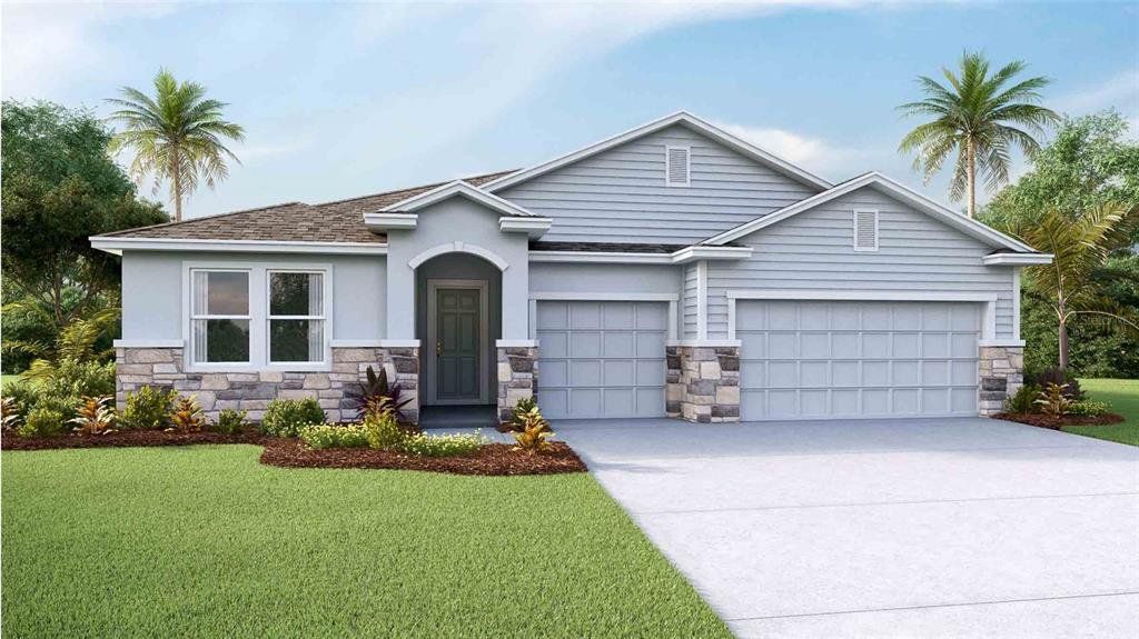 Front exterior of a new home in Woodcreek, Wesley Chapel, FL, highlighting curb appeal (Image 1). Front exterior of a new home in Woodcreek, Wesley Chapel, FL, highlighting curb appeal (Image 1).
