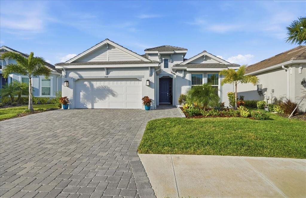 Front exterior of a new home in Esplanade at Artisan Lakes, Palmetto, FL, highlighting curb appeal (Image 1). Front exterior of a new home in Esplanade at Artisan Lakes, Palmetto, FL, highlighting curb appeal (Image 1).