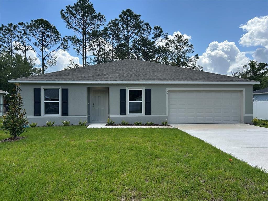 Front exterior of a new home in Palm Coast, Palm Coast, FL, highlighting curb appeal (Image 1). Front exterior of a new home in Palm Coast, Palm Coast, FL, highlighting curb appeal (Image 1).