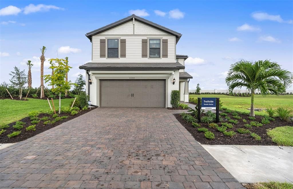 Front exterior of a new home in Talon Preserve on Palmer Ranch, Nokomis, FL, highlighting curb appeal (Image 1). Front exterior of a new home in Talon Preserve on Palmer Ranch, Nokomis, FL, highlighting curb appeal (Image 1).