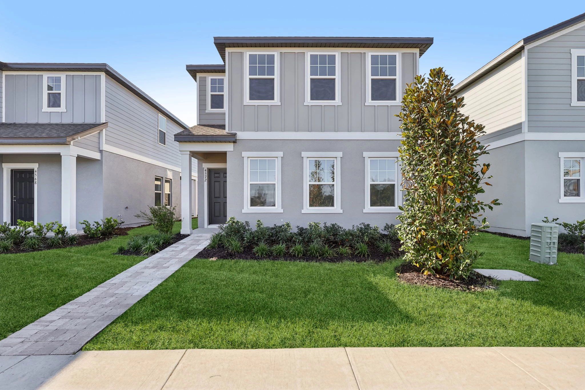 Front exterior of a new home in Hawks Run, Kissimmee, FL, highlighting curb appeal (Image 1).