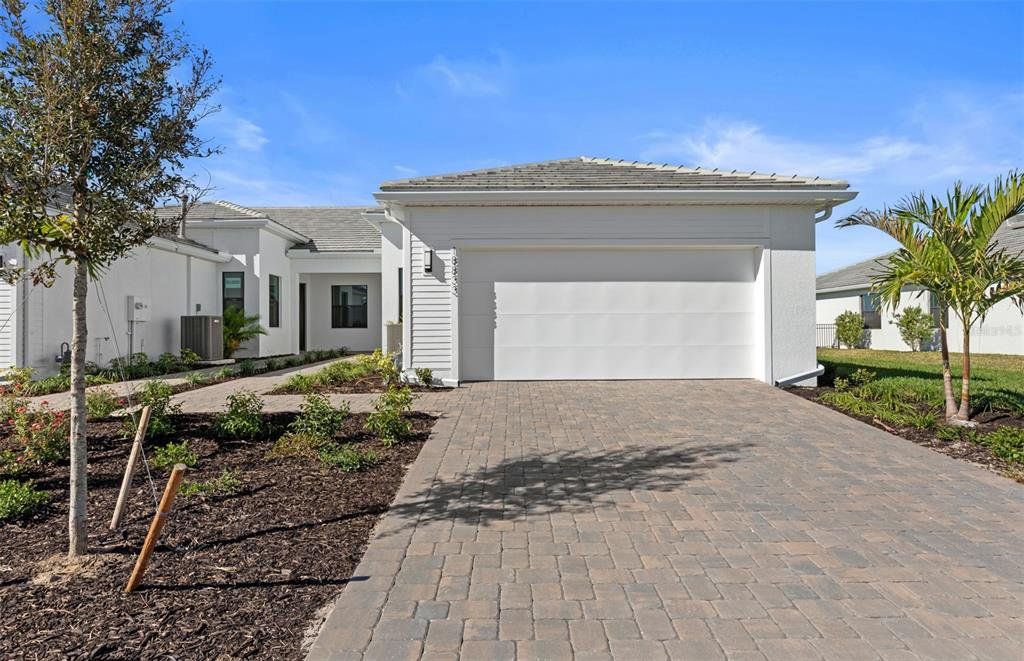 Front exterior of a new home in Del Webb Catalina, Lakewood Ranch, FL, highlighting curb appeal (Image 1). Front exterior of a new home in Del Webb Catalina, Lakewood Ranch, FL, highlighting curb appeal (Image 1).